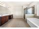 Primary bathroom with double vanity, tub, and glass shower at 3750 Lake Haven Way, Atlanta, GA 30349
