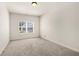This bedroom has white walls, carpeted floors, a window, and a ceiling light at 3750 Lake Haven Way, Atlanta, GA 30349