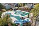 Community pool with slides and water features, surrounded by trees and a spacious deck at 3750 Lake Haven Way, Atlanta, GA 30349
