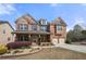 Inviting brick home boasts a covered porch, well-manicured lawn, and an attached two-car garage at 3750 Lake Haven Way, Atlanta, GA 30349