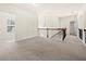 Upstairs hallway features carpet flooring, a stylish chandelier, and easy access to bedrooms and bathrooms at 3750 Lake Haven Way, Atlanta, GA 30349
