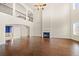 Spacious living room with fireplace, hardwood floors, and staircase to upper level at 3750 Lake Haven Way, Atlanta, GA 30349