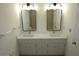 Bathroom featuring a double sink vanity with modern fixtures and a mirror over each sink at 4631 Calumet Cir, Duluth, GA 30096