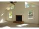 Inviting living room with a fireplace, ceiling fan, and large windows that bring in plenty of light at 4631 Calumet Cir, Duluth, GA 30096
