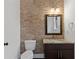 Half bathroom featuring stone accent wall, granite countertop, and dark wood vanity at 482 Pearl Cove Ct, Atlanta, GA 30350