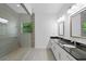 Modern bathroom with a glass-enclosed shower, double vanity, and gray tile at 482 Pearl Cove Ct, Atlanta, GA 30350