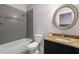 Stylish bathroom with tiled walls, granite countertop and large vanity mirror at 482 Pearl Cove Ct, Atlanta, GA 30350