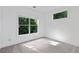 Bright bedroom featuring carpeted floor and tree lined views at 482 Pearl Cove Ct, Atlanta, GA 30350