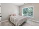 Cozy bedroom with natural light, carpeted floor, and serene window view at 482 Pearl Cove Ct, Atlanta, GA 30350