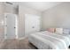 Neutral bedroom featuring a bed, carpet, closet, and an adjoining door at 482 Pearl Cove Ct, Atlanta, GA 30350