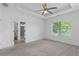 Bedroom with carpet, tray ceiling and view to the attached bathroom at 482 Pearl Cove Ct, Atlanta, GA 30350