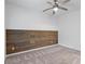 Minimalist bedroom design with a wood accent wall and carpeted floors at 482 Pearl Cove Ct, Atlanta, GA 30350