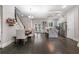 Open concept living space with a dining table and view of the bright, modern kitchen at 482 Pearl Cove Ct, Atlanta, GA 30350