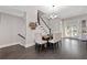 Dining room with dark hardwood floors, staircase, and wine rack at 482 Pearl Cove Ct, Atlanta, GA 30350