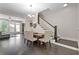 Light-filled dining room with dark hardwood floors, wooden table, and stairway to the second floor at 482 Pearl Cove Ct, Atlanta, GA 30350