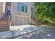 Exterior of townhome featuring a two-car garage, brick facade, and multiple stairs leading up to the entry at 482 Pearl Cove Ct, Atlanta, GA 30350
