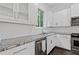 Modern kitchen featuring white cabinets, stainless steel appliances and granite counters at 482 Pearl Cove Ct, Atlanta, GA 30350