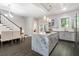 Spacious kitchen with a large island, stainless appliances, and a view of the staircase at 482 Pearl Cove Ct, Atlanta, GA 30350
