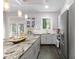 Well-lit kitchen with gray cabinets, a granite countertop island, and stainless steel appliances at 482 Pearl Cove Ct, Atlanta, GA 30350