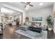 Open concept living room featuring a gray sectional, kitchen with a marble island, and hardwood floors at 482 Pearl Cove Ct, Atlanta, GA 30350