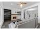Bright living room with a stone fireplace, dark wood floors, and a comfortable gray sectional at 482 Pearl Cove Ct, Atlanta, GA 30350