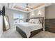 A spacious main bedroom with tray ceiling, carpet, and dark wood furniture at 482 Pearl Cove Ct, Atlanta, GA 30350