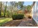 Inviting backyard featuring a patio, wooden deck, pergola and lush landscaping at 1488 Drayton Woods Dr, Tucker, GA 30084