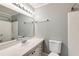 Bathroom featuring grey walls, toilet, sink, and mirror with a shower in view at 1488 Drayton Woods Dr, Tucker, GA 30084