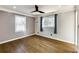 This bedroom features hardwood floors, a ceiling fan, and natural light from two windows at 1488 Drayton Woods Dr, Tucker, GA 30084
