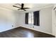 This bedroom features hardwood floors, a ceiling fan, and natural light from a window at 1488 Drayton Woods Dr, Tucker, GA 30084