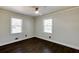 This bedroom features hardwood floors and natural light from two windows with blinds at 1488 Drayton Woods Dr, Tucker, GA 30084