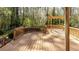 Wooden deck in back of property shows natural landscape and pergola at 1488 Drayton Woods Dr, Tucker, GA 30084