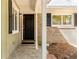 Covered front porch with stone flooring, a dark front door, and white support columns creating an inviting entrance at 1488 Drayton Woods Dr, Tucker, GA 30084