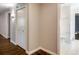 Hallway with hardwood floors, closet and bathroom access, and neutral paint throughout at 1488 Drayton Woods Dr, Tucker, GA 30084