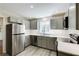 Modern kitchen features stainless steel appliances, gray cabinets, and white subway tile backsplash at 1488 Drayton Woods Dr, Tucker, GA 30084