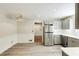 Bright dining area leading into kitchen with stainless steel appliances and grey cabinets at 1488 Drayton Woods Dr, Tucker, GA 30084
