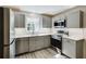 Updated kitchen boasts stainless steel appliances, grey cabinetry, and bright white countertops at 1488 Drayton Woods Dr, Tucker, GA 30084