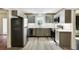 Modern kitchen featuring sleek gray cabinets, stainless steel appliances, quartz countertops, and stylish flooring at 1488 Drayton Woods Dr, Tucker, GA 30084