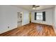 Sunlit living room with hardwood floors and adjacent room with built in shelving at 1488 Drayton Woods Dr, Tucker, GA 30084