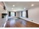 Spacious living room with wood paneled wall, dark hardwood floors, and two large windows providing ample light at 1488 Drayton Woods Dr, Tucker, GA 30084