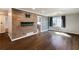 Open living room featuring wood paneled accent wall, hardwood floors, and natural light from the large window at 1488 Drayton Woods Dr, Tucker, GA 30084