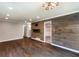 Bright living room with hardwood floors, shiplap accent wall, and stylish light fixture at 1488 Drayton Woods Dr, Tucker, GA 30084