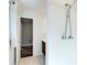 Bathroom tiled shower with tile floors, white walls, and door to the next room at 1488 Drayton Woods Dr, Tucker, GA 30084