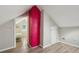 Attic area with bright red brick accent and view into bedroom with white iron bed frame at 1591 Athens Sw Ave, Atlanta, GA 30310