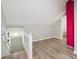 Attic with light wood flooring, white railing, and distinctive red brick column feature at 1591 Athens Sw Ave, Atlanta, GA 30310