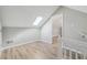 Bright attic space with light wood flooring and a skylight, providing natural light at 1591 Athens Sw Ave, Atlanta, GA 30310