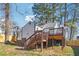 Well-maintained backyard with a wooden deck and stairs, ideal for outdoor activities and relaxation at 1591 Athens Sw Ave, Atlanta, GA 30310
