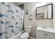 Cozy bathroom with a blue fish-themed shower curtain, toilet, and vanity at 1591 Athens Sw Ave, Atlanta, GA 30310
