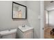 Modern bathroom featuring a white vanity, toilet, and framed mirror at 1591 Athens Sw Ave, Atlanta, GA 30310