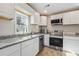 Stylish kitchen featuring stainless steel appliances, granite countertops, and modern fixtures at 1591 Athens Sw Ave, Atlanta, GA 30310